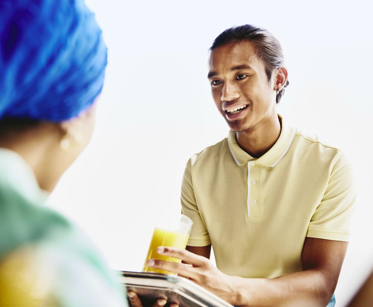 Waiter serving a drink to a woman. Waiter serving a drink to a woman.