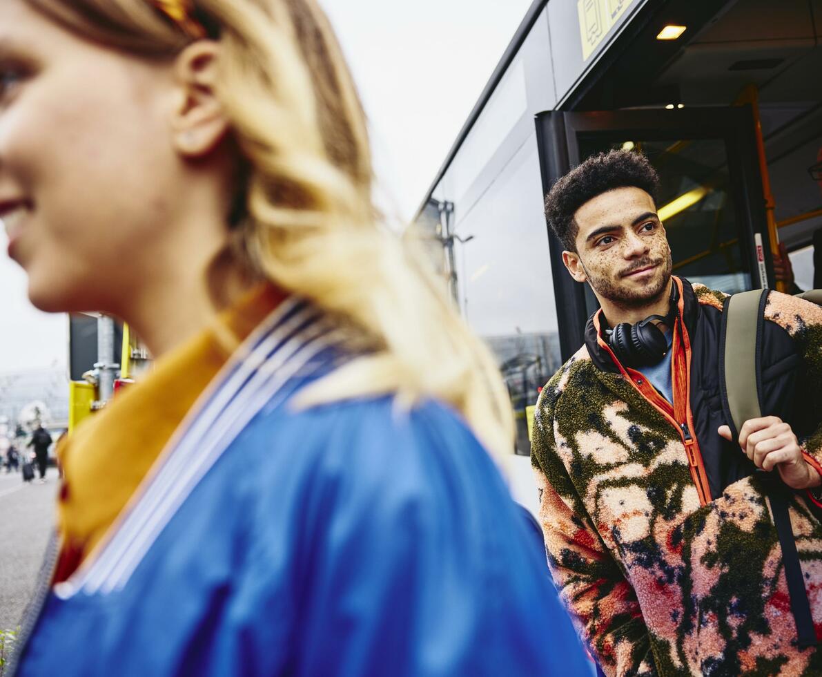 People getting out of a bus.