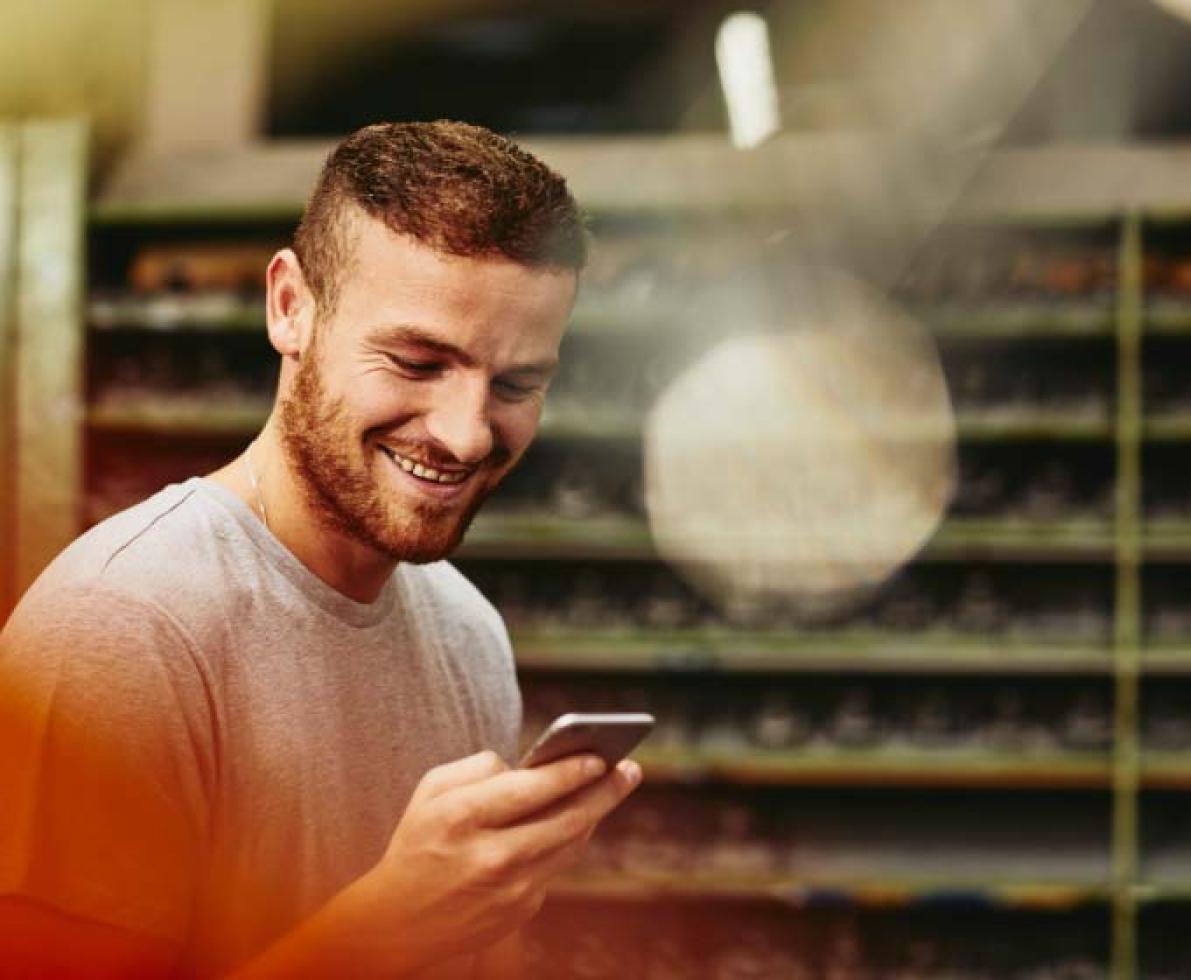 man smiling holding his phone