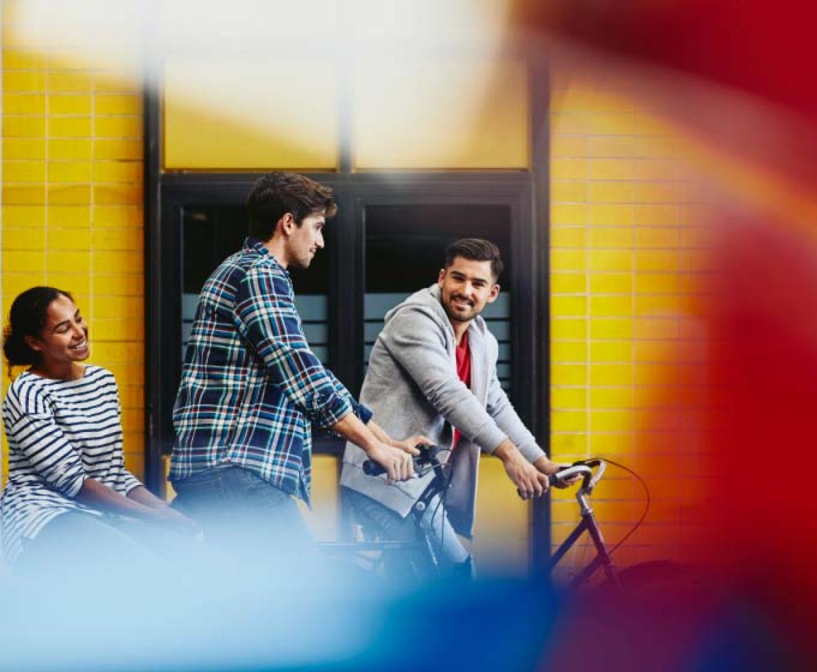 two men chatting next to their bicycles